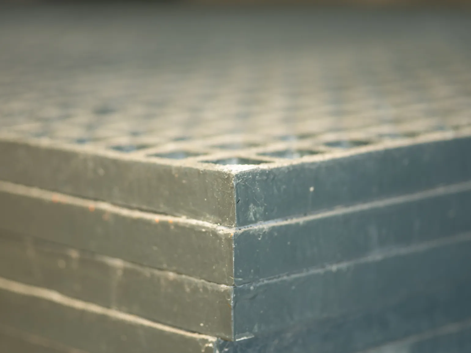 What is Fibre Reinforced Polymer?

Fibre reinforced polymer is an umbrella term that encompasses all composite materials that contain both fibres and polymer matrices. The fibres used can range from glass, as in the case of GRP, to Kevlar, basalt, carbon and more. The polymers used include epoxy resin, vinyl ester, and polyester.

Fibre reinforced polymers, including fibreglass, are lightweight, robust, and strong, offering comparable strength to much heavier materials like steel. This makes them well suited for use in applications where weight is a factor, such as the automotive industry. FRPs are also corrosion resistant and can withstand exposure to the elements and certain chemicals, making them suitable for harsh and industrial environments. They can be moulded into different shapes to suit a range of applications, and many are effective electrical insulators.
